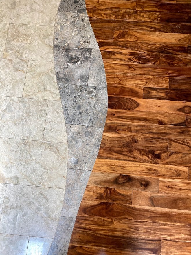hardwood floor installed against marble