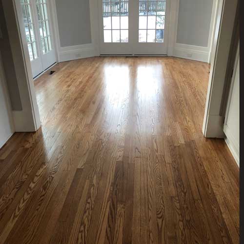 Refinished hardwood floor in a Raleigh NC home after dustless sanding and staining